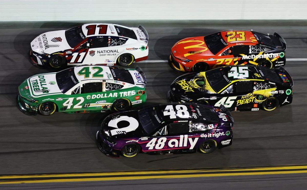 DAYTONA BEACH, FLORIDA - FEBRUARY 16: Alex Bowman, driver of the #48 Ally Chevrolet, John H. Nemechek, driver of the #42 Dollar Tree Toyota, Denny Hamlin, driver of the #11 National Debt Relief Toyota, Tyler Reddick, driver of the #45 Nasty Beast Toyota and Bubba Wallace, driver of the #23 McDonald's Toyota race during the NASCAR Cup Series Daytona 500 at Daytona International Speedway on February 16, 2025 in Daytona Beach, Florida. (Photo by Meg Oliphant/Getty Images)