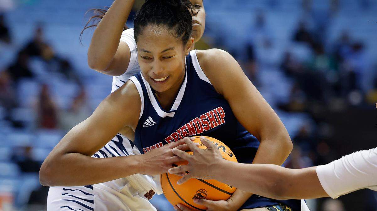 Chambers’ Amiaya Hall (12) and Chambers’ Mila Holloway (10) guard Apex Friendship’s Indya Nivar (12) during the NCHSAA 4A state championship game at the Smith Center in Chapel Hill, N.C., Saturday, March 12, 2022. Chambers beat Apex Friendship 46-44.