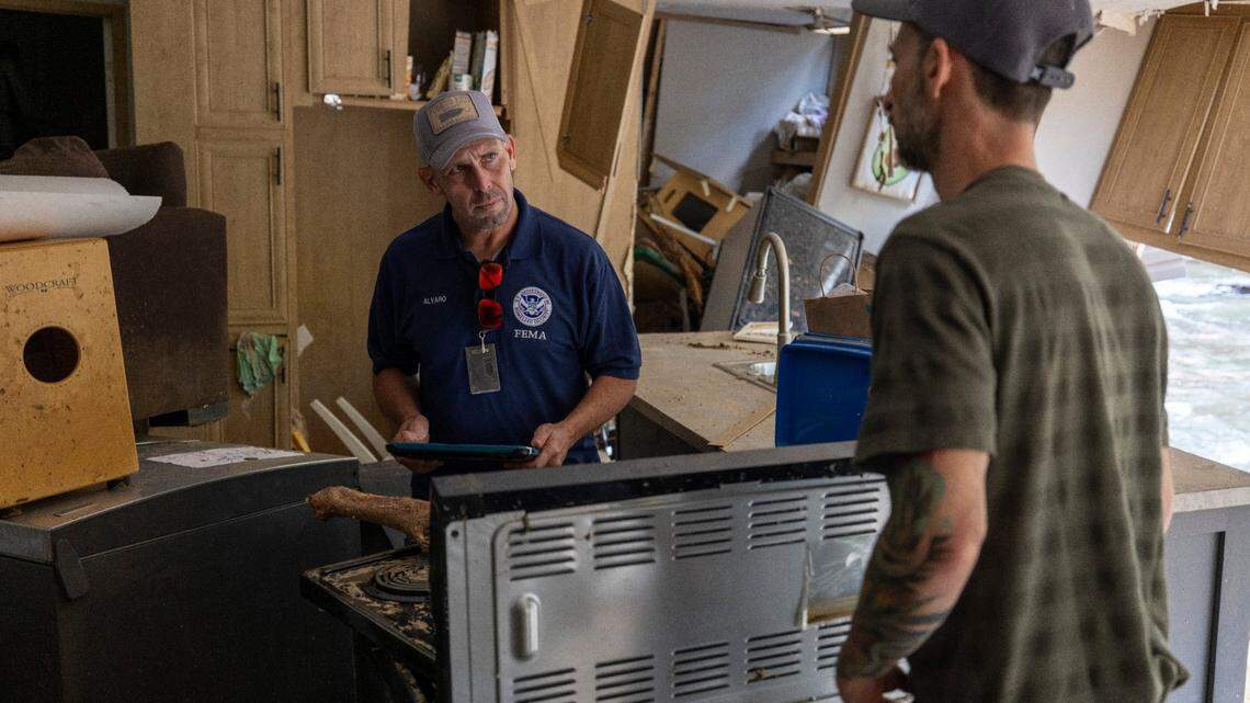 FEMA employee Jirau Alvaro works with Daniel Mancini, doing a report on the damage to his property on Sunday, October 6, 2024 in rural Buncombe County, near Black Mountain, N.C.