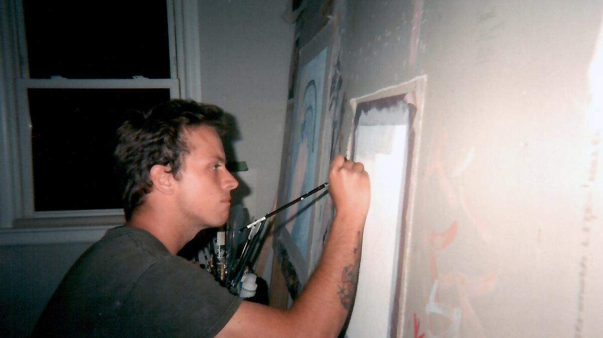 Dustin Brown paints in his Charlotte studio. Some of Brown’s work is being featured through July 31 as part of the Creature Comforts exhibition at Tchotchke Gallery in New York City.