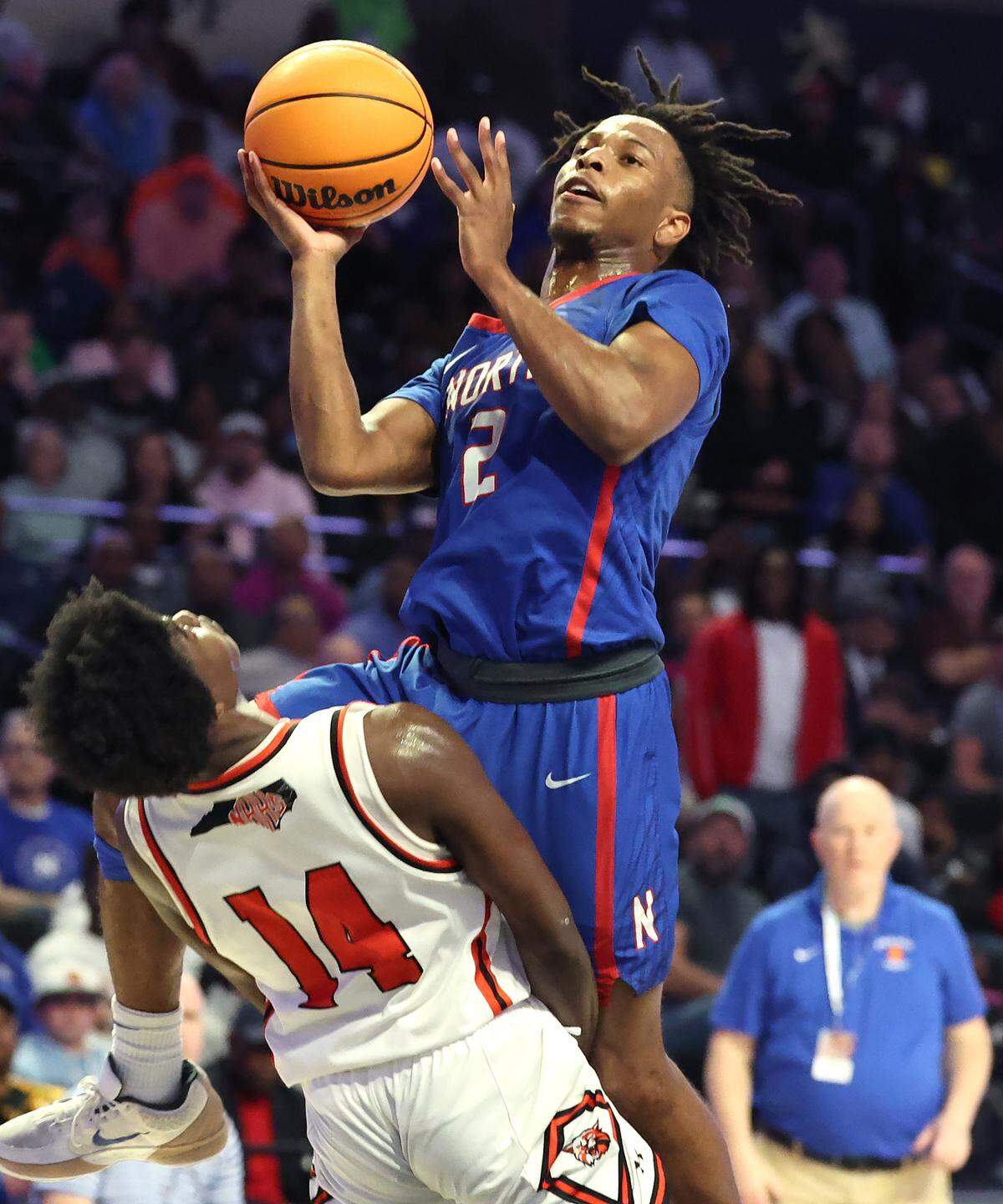 North Meck’s Carson Evans, right, drives into the lane for a shot against New Hanover defender Jazir Wright-McGhee, left, on Saturday, March 15, 2025. North Meck defeated New Hanover 59-56 in the boys NCHSAA 4A State Championship game at Lawrence Joel Veterans Coliseum in Winston-Salem, NC.