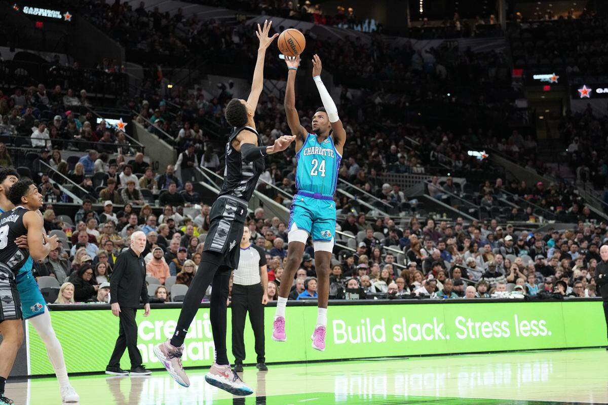 Charlotte Hornets forward Brandon Miller (24) shoots over San Antonio Spurs center Victor Wembanyama (1) in the first half at Frost Bank Center.