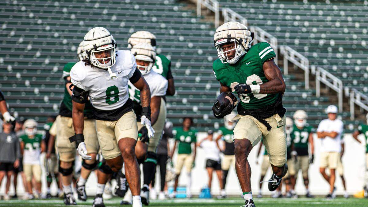 Hahsaun Wilson rushes toward the end zone during Charlotte 49ers football practice in Charlotte, N.C., at Jerry Richardson Stadium.