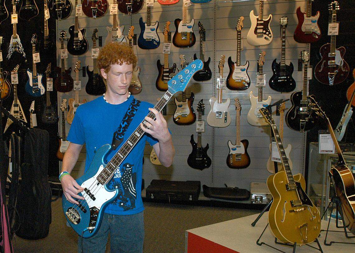 Sam Ash stores nationwide have begin going-out-of-business sales. The music store in Charlotte, seen with a young man rocking out in this 2008 file photo, has long been a staple in the city.