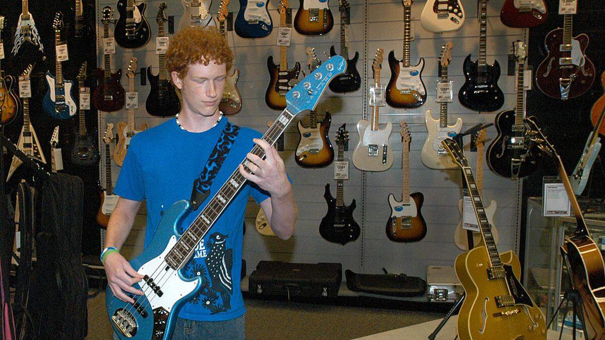 Sam Ash stores nationwide have begun going-out-of-business sales. A young man rocking out in the Charlotte, NC, store is shown in this 2008 file photo.