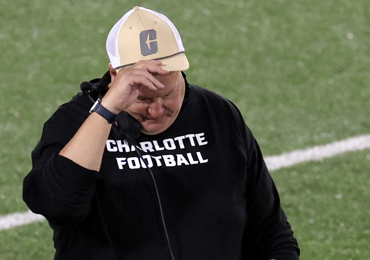 Charlotte 49ers head coach Biff Poggi tugs on his cap after a failed series against South Florida on Saturday, November 16, 2024 at Jerry Richardson Stadium.