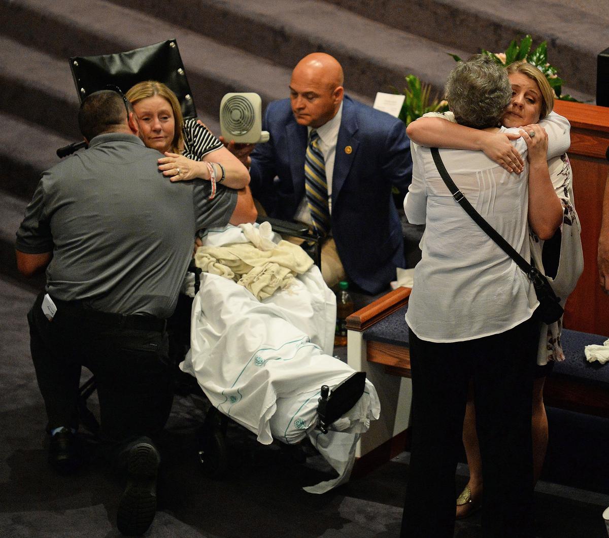 Dianne Self, left, mother of Katelyn Self, and Taylor Potter, far right, Katelyn Self’s sister, hug friends at the First Assembly of God Church in Gastonia. Katelyn Self died when her father drove a Jeep into a restaurant where the family was dining in Bessemer City.