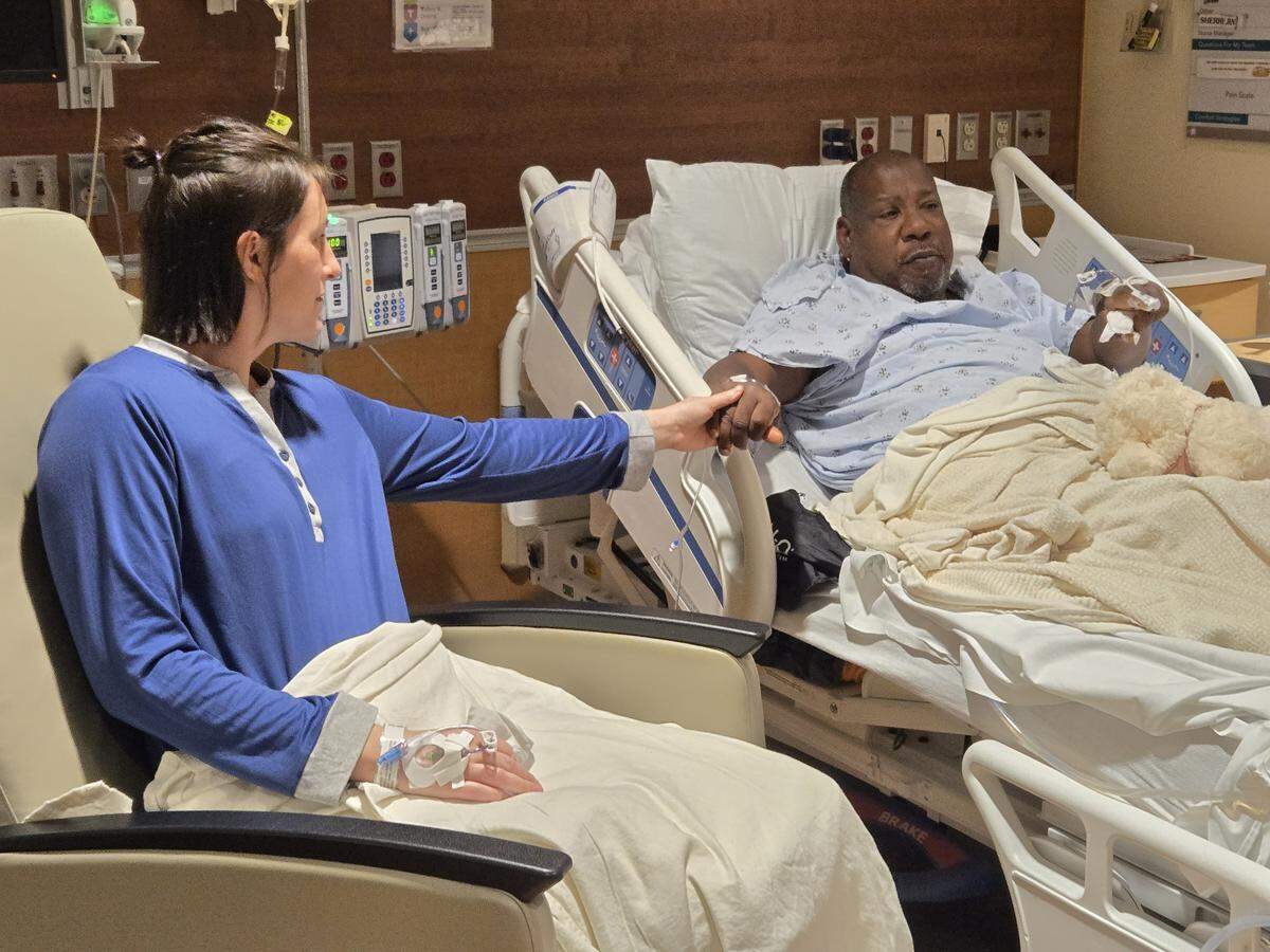 Heather Patrek and Dr. Anthony J. Davis hold hands shortly after meeting for the first time at the hospital after their surgeries.