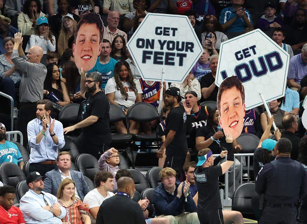Large poster boards of Charlotte Hornets forward Kon Knueppel’s face are carried through the arena after he broke the team record for most made 3-point shots in a season against Phoenix on April 2.