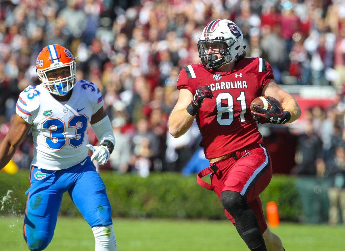 South Carolina tight end Hayden Hurst (81) takes off past Florida linebacker David Reese (33) after a reception during of the first half of a game at Williams-Brice Stadium in Columbia, SC, Saturday, November 11, 2017. Hurst played three years for the Gamecocks from 2015-17, then went pro and became a first-round draft pick in the 2018 NFL draft, going No. 25 overall to the Baltimore Ravens.