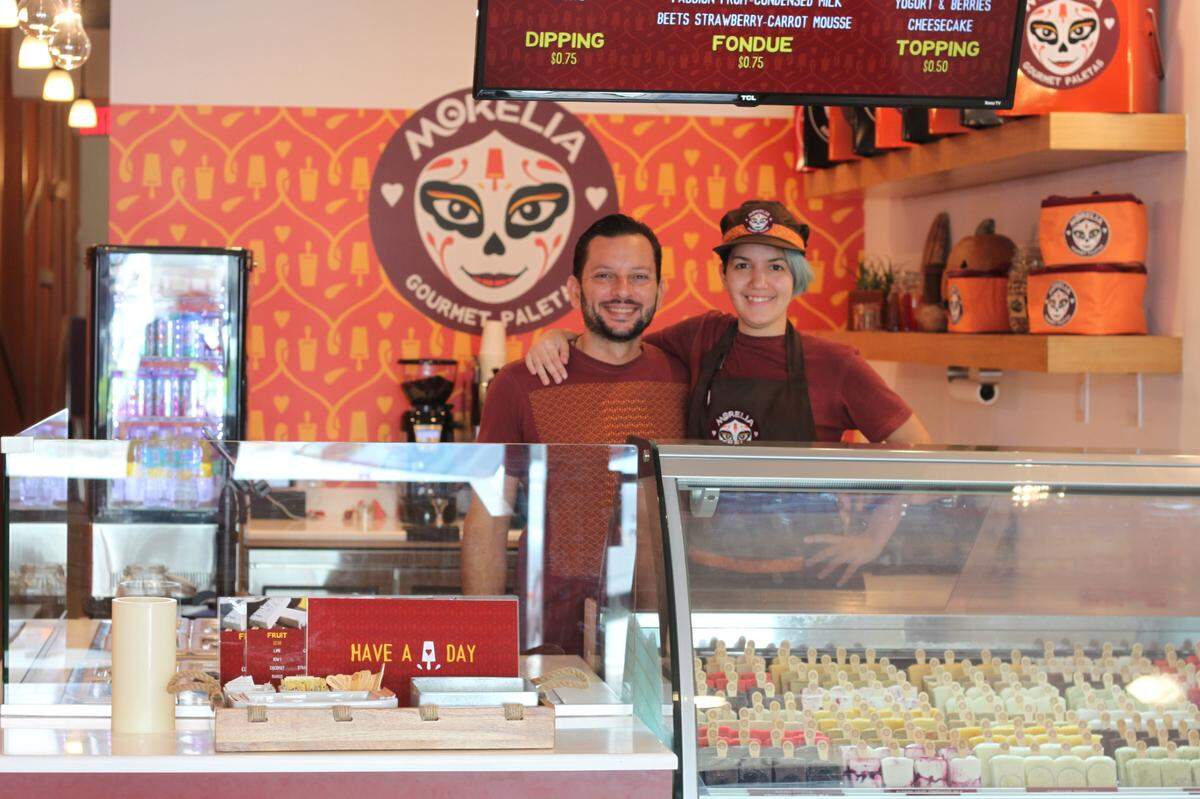At Morelia Gourmet Paletas, customers pick their pops, then dip them and add toppings.