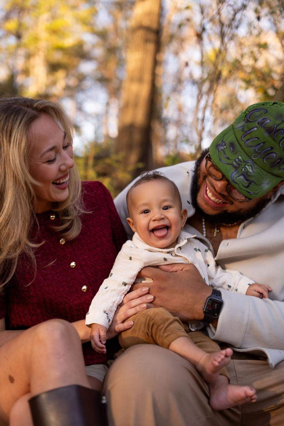 Carolina Panthers guard Robert Hunt (right) poses with wife, Julia, and son, Skye.