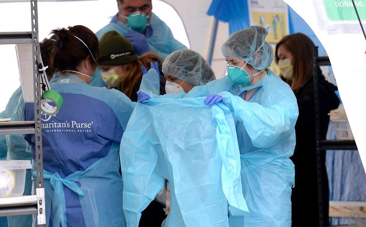 Samaritan’s Purse nurses don protective wear and equipment inside the donning area at the emergency field hospital at Caldwell Memorial Hospital on Thursday, January 7, 2020 in Lenoir, NC.