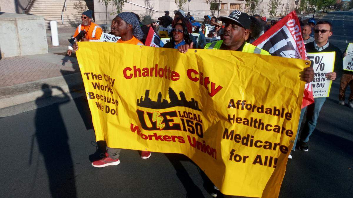 Members of the Charlotte City Workers Union march down 3rd Street on Monday to push for increased wages and improved overtime pay.