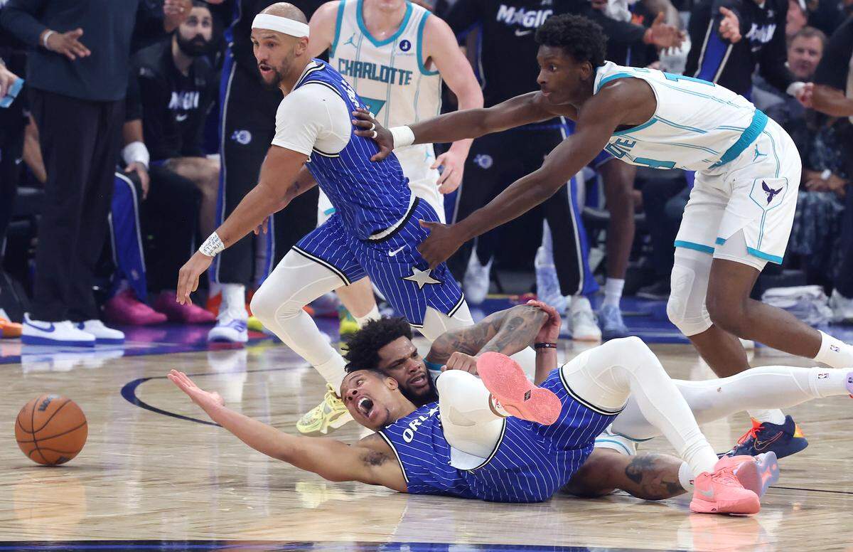 Orlando Magic guard Desmond Bane, left, stretches out trying to regain control of a loose ball with Charlotte Hornets forward Miles Bridges, right, during action at Kia Center in Orlando, FL on Friday, April 17, 2026.