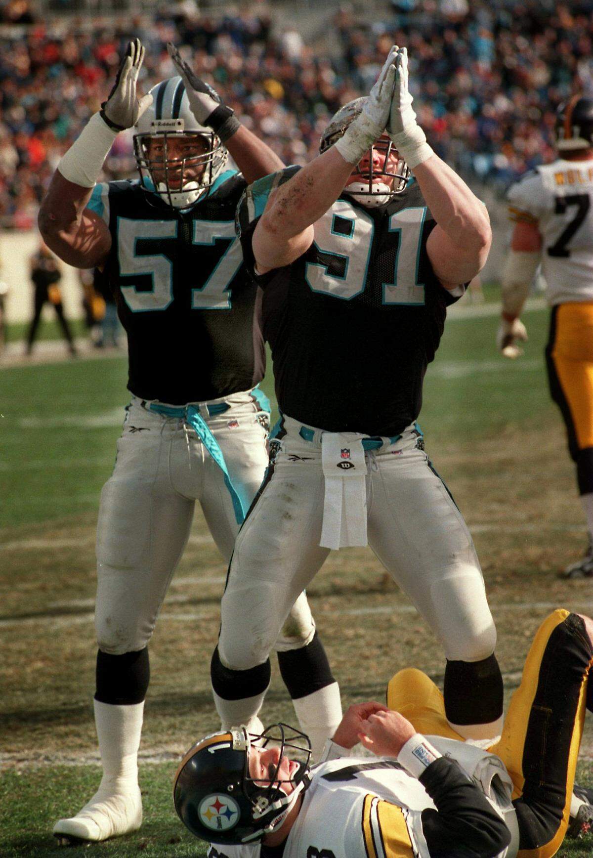 12/23/96 12B DAVID T. FOSTER III/Staff Carolina’s Kevin Greene (91) and Lamar Lathon signal a safety after Pittsburgh quarterback Mike Tomczak (bottom) was called for intentional grounding in the end zone. (UNPUBLISHED NOTES:) (12/22/96)Carolina Panthers Kevin Greene (91) and Lamar Lathon (57) signal a safety after Pittsburgh QB Mike Tomczak, on ground, was called for intentional grounding. David T. Foster III/Staff