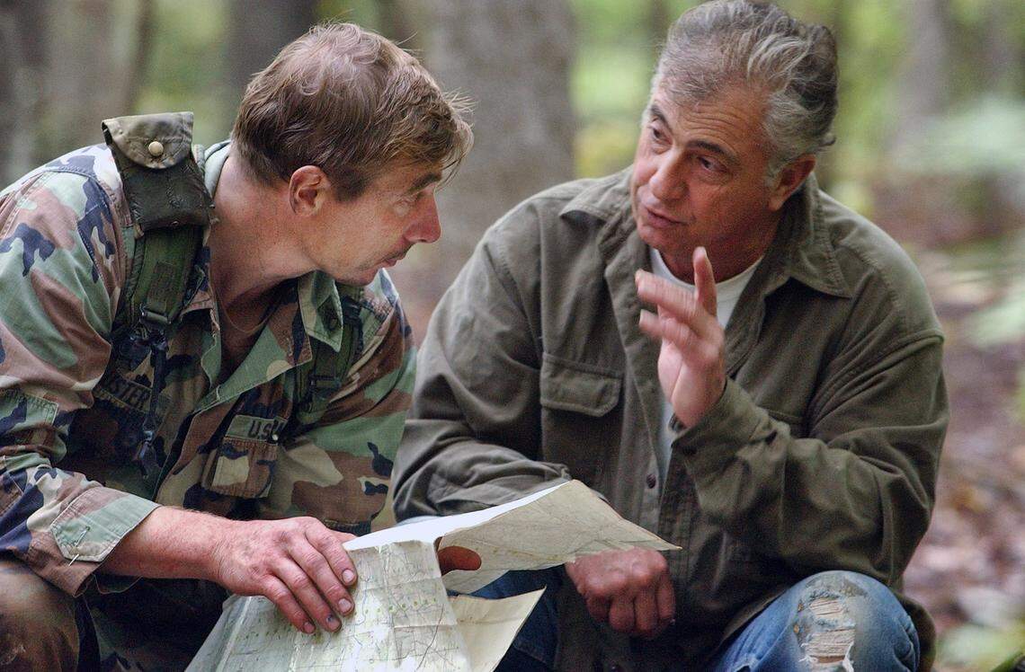 Don Brochu (right) speaks with Special Forces trainee SSgt Chris Buster about map co-ordinates for opposition forces during the Robin Sage training exercise. Brochu not only volunteers his time as one of the “actors” in the training but allows the Special Forces to use his land in the various scenarios.
