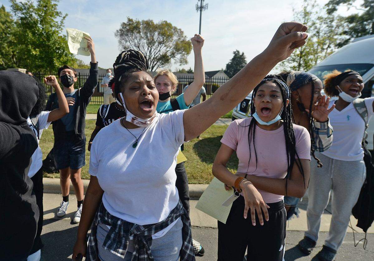 Olympic High students protest outside the school on Friday, October 1, 2021 in Charlotte, NC. Last week, a 15-year-old student was charged with sexual assault of a female student. Another student, a football player had been accused in two assaults and told to wear an ankle monitor. The athlete played in last weekÕs football game wearing the monitor. Students are upset over the lax enforcement of penalties and organized a boycott of school on Friday.