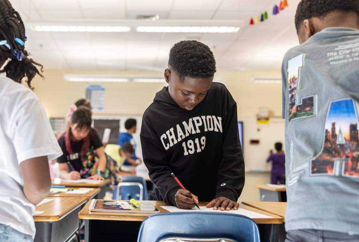 Students get started on their first assignment of the day during the first day of school at Elizabeth Traditional School in Charlotte, N.C., on Monday, August 25, 2025.