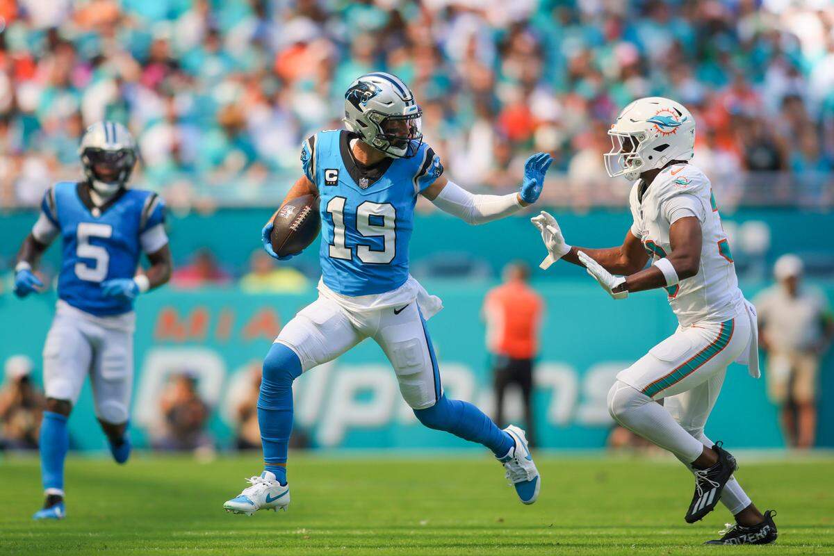 Oct 15, 2023; Miami Gardens, Florida, USA; Carolina Panthers running back Tarik Cohen (33) runs with the football against Miami Dolphins cornerback Eli Apple (33) during the first quarter at Hard Rock Stadium. Mandatory Credit: Sam Navarro-USA TODAY Sports