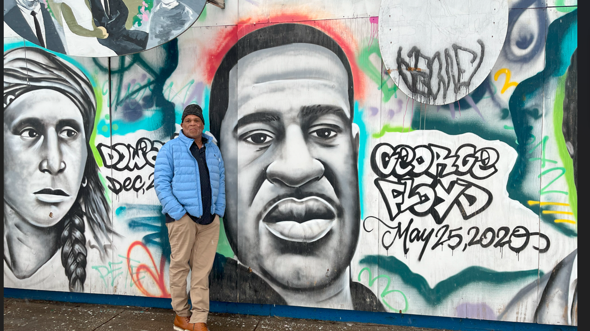 Selwyn Jones stands at a mural of his nephew, George Floyd, in Minneapolis, Minnesota.