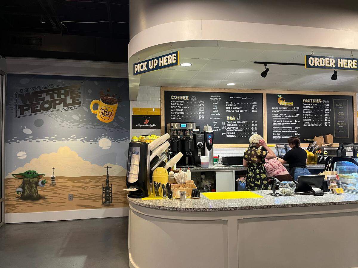 Charlotte artist Mike Wirth created the “We the People’ mural near the ordering counter at The People’s Market in Elizabeth.