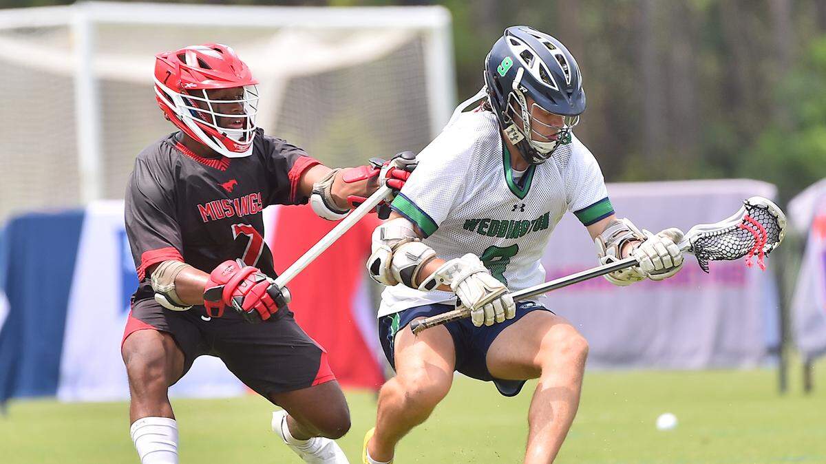 Middle Creek’s Joshua High defend Weddington’s Michael Cooper (9) during the first half. The Middle Creek Mustangs and the Weddington Warriors met in the NCHSAA 4A Men’s Lacrosse championships n Cary, N.C. on May 21, 2020