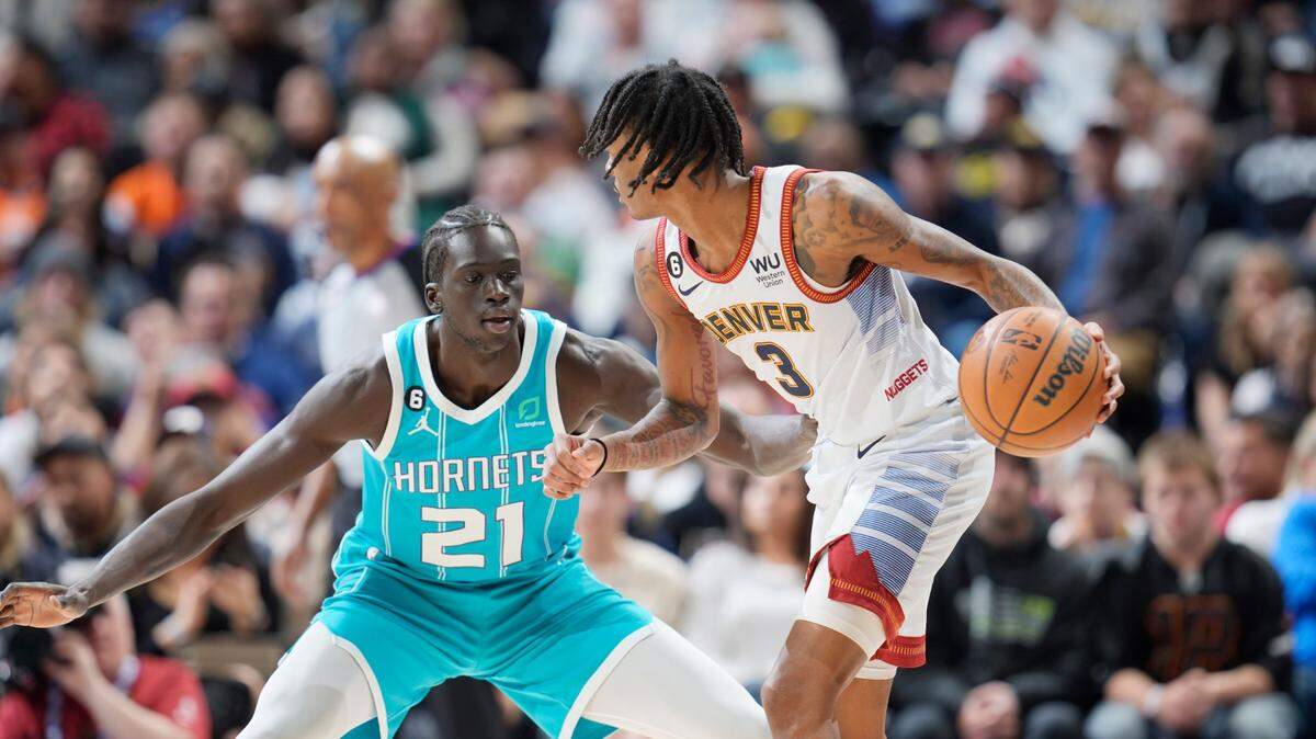Denver Nuggets guard Bones Hyland (3) and Charlotte Hornets forward JT Thor (21) in the second half of an NBA basketball game Sunday, Dec. 18, 2022, in Denver. (AP Photo/David Zalubowski)