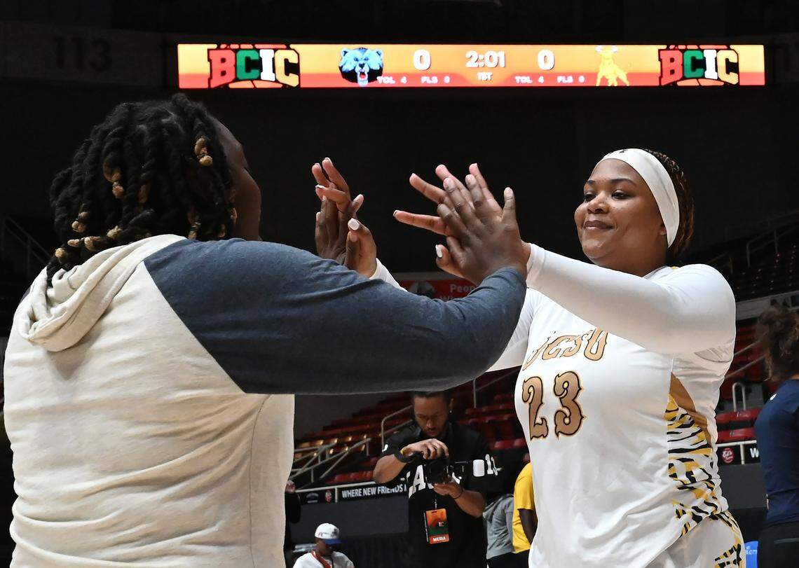 Johnson C. Smith University’s Rylee Ghent, right, is welcomed to the floor by a teammate during player introductions at Bojangles Coliseum in Charlotte, NC on Thursday, March 20, 2025. JCSU faced Livingstone College in first day action of the Black College Invitational Championship (BCIC).