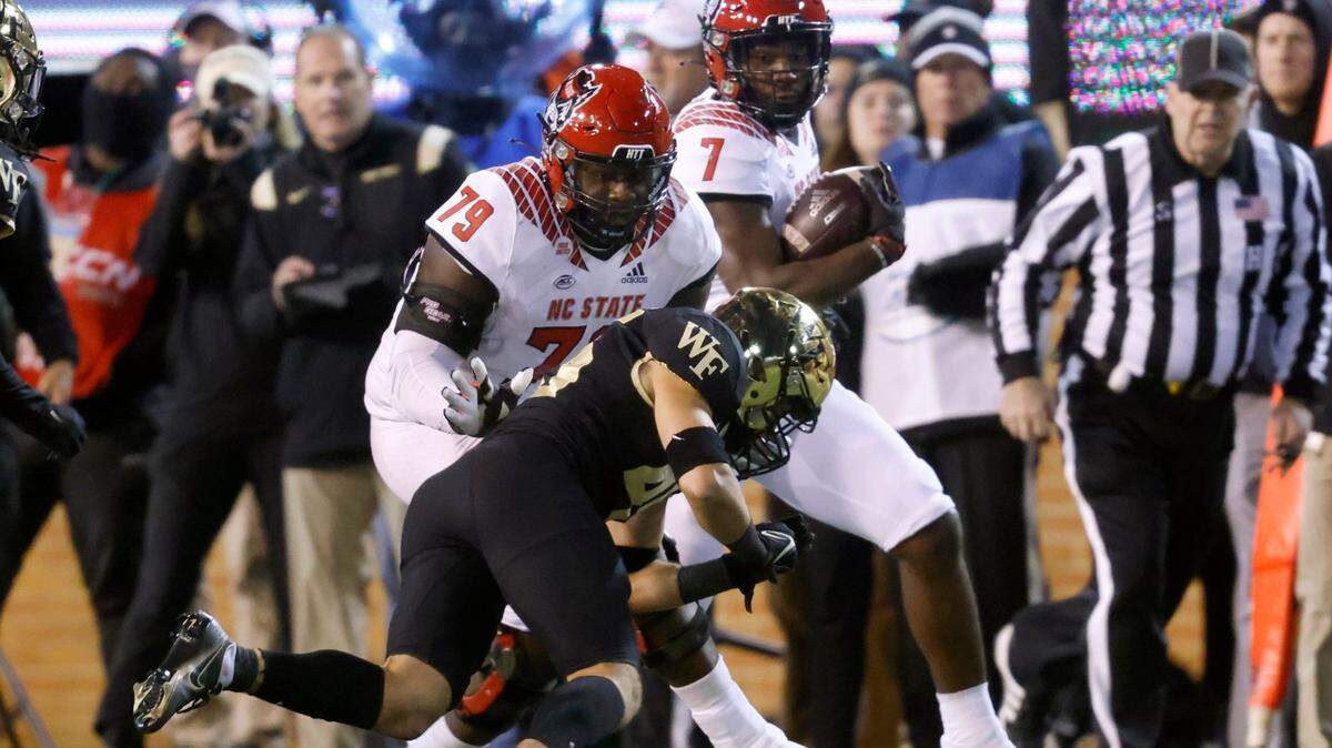 N.C. State offensive tackle Ikem Ekwonu (79) blocks Wake Forest defensive back Nick Andersen (45) as Zonovan ‘Bam’ Knight (7) gains yards during the first half of N.C. States game against Wake Forest at Truist Field in Winston-Salem, N.C., Saturday, November 13, 2021.