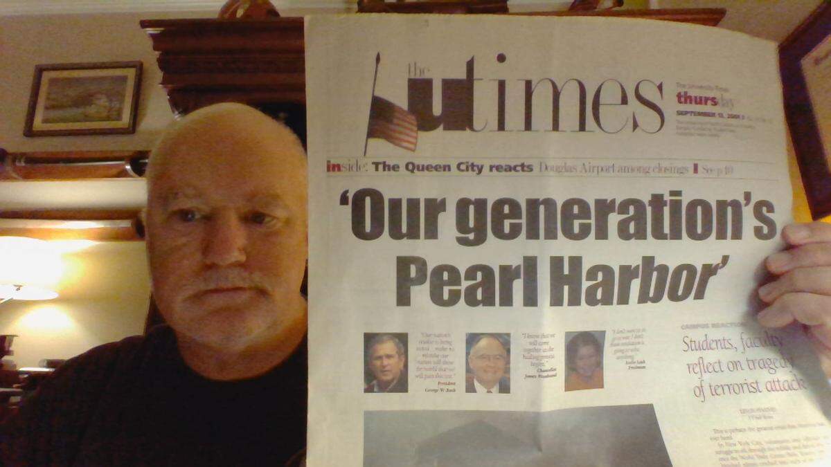 UNC Charlotte professor Steve Sabol saves newspapers from important events in history. Here he is pictured holding the university’s student newspaper from Sept. 13, 2001.