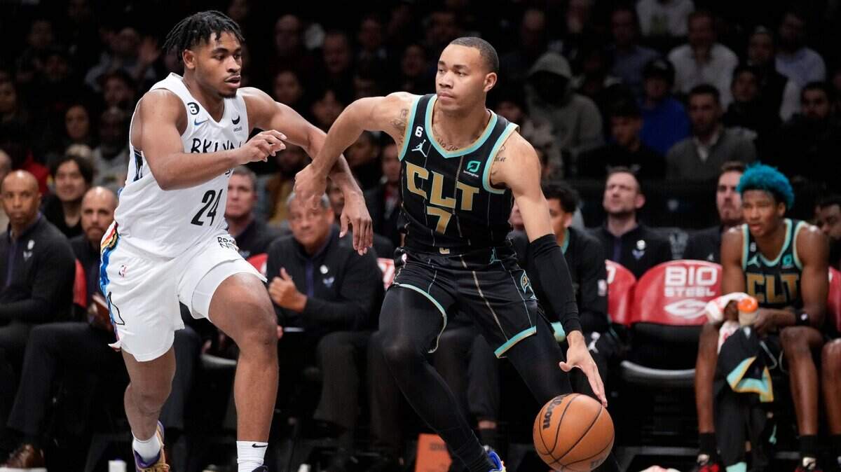 Charlotte Hornets guard Bryce McGowens (7) drives past Brooklyn Nets guard Cam Thomas (24) during the first half of an NBA basketball game, Wednesday, Dec. 7, 2022, in New York. (AP Photo/John Minchillo)