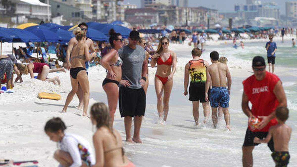 Beachgoers enjoy a sunny day in Destin, Fla., Wednesday, March 18, 2020. There’s a new type of social policing out there that’s developed almost as quickly as the viral disease that spurred its arrival. It’s called “quarantine shaming,” calling out those who are leaving the house for daily activities or who aren’t abiding by social distancing rules. And it’s part of a new reality for Americans who must navigate a world of rapidly evolving social norms in the age of COVID-19.
