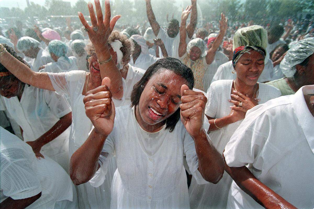 10/11/98 A woman is baptized Sunday morning during a service that drew thousands to the United House of Prayer for All People on Freedom Drive.