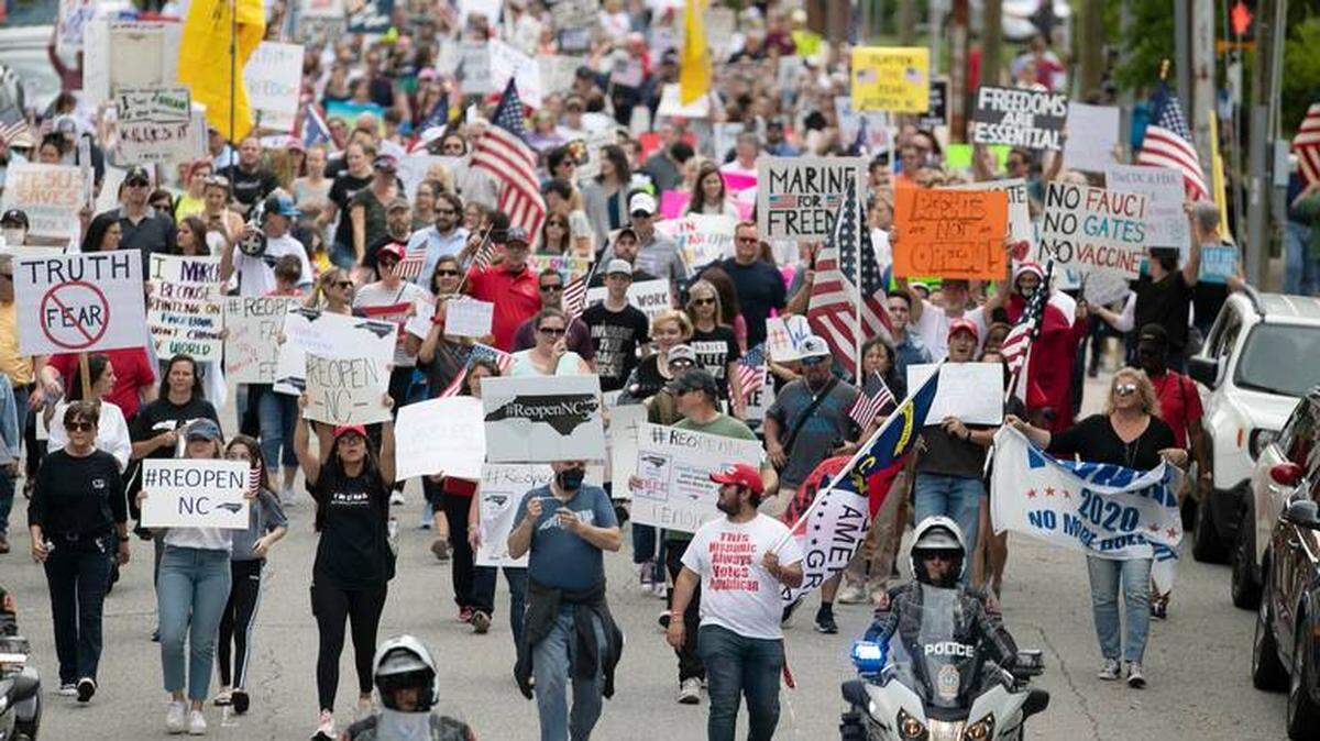 Protesters from ReOpenNC filled Lane Street in Raleigh on Tuesday. They are calling on N.C. Gov. Roy Cooper to ease COVID-19 restrictions due to economic concerns.