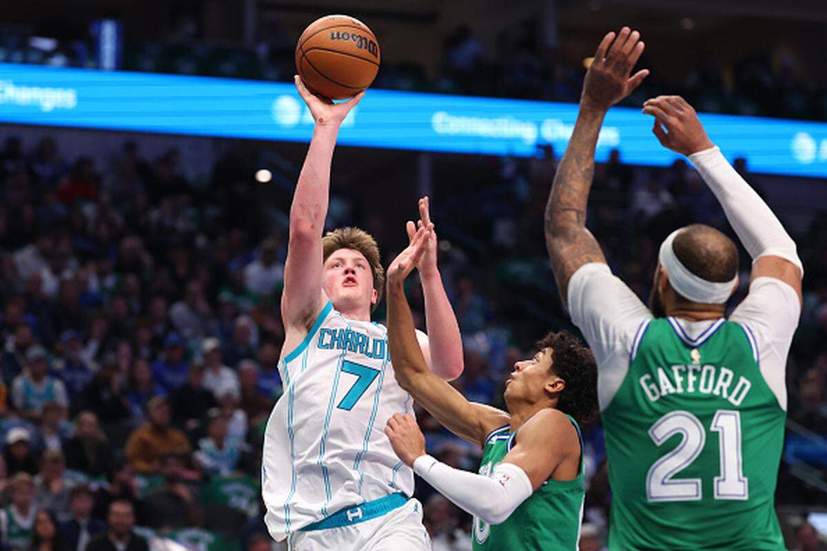 Kon Knueppel of the Charlotte Hornets shoots as Max Christie and Daniel Gafford of the Dallas Mavericks defend during the second quarter at American Airlines Center.
