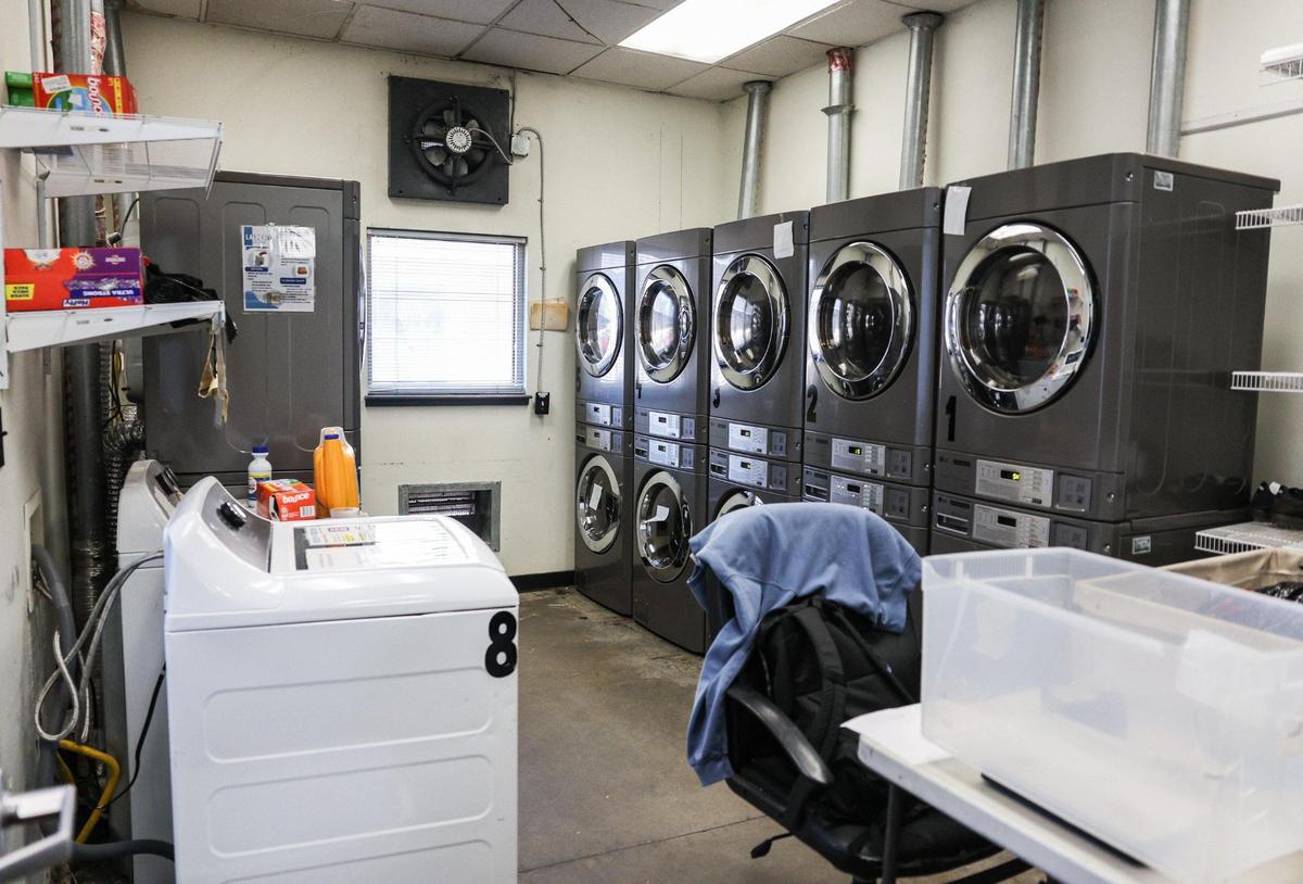 Washers and driers make up a small but busy laundry room at Roof Above Day Center. With homelesness on the rise, services offered at the center help people experiencing homelessness maintain their dignity.