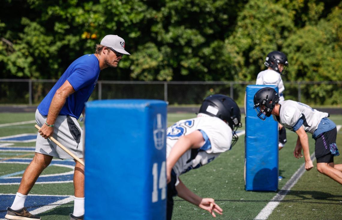 Former Carolina Panthers tight end Greg Olsen coaches players with Charlotte Christian middle school during football practice on Wednesday, August 22, 2024.