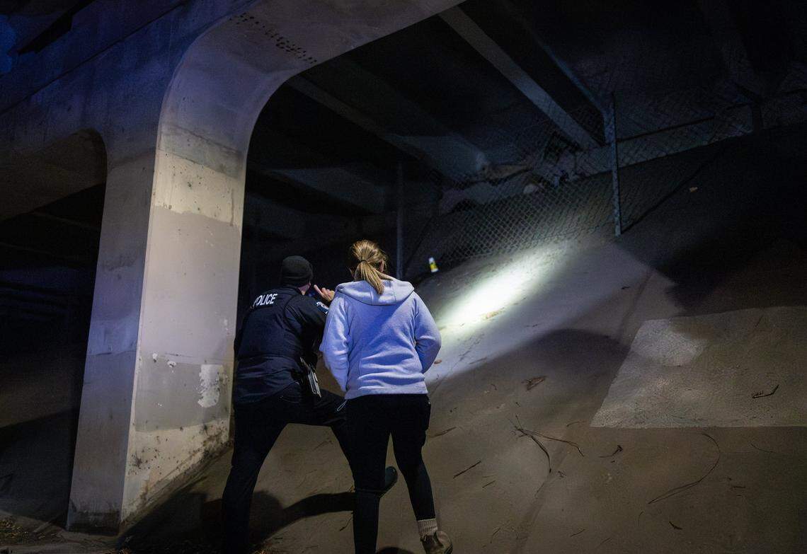 Allison Winston and an officer check on an unhoused person during the 2026 Point-in-Time Count in Charlotte, N.C., on Thursday, January 22, 2026.