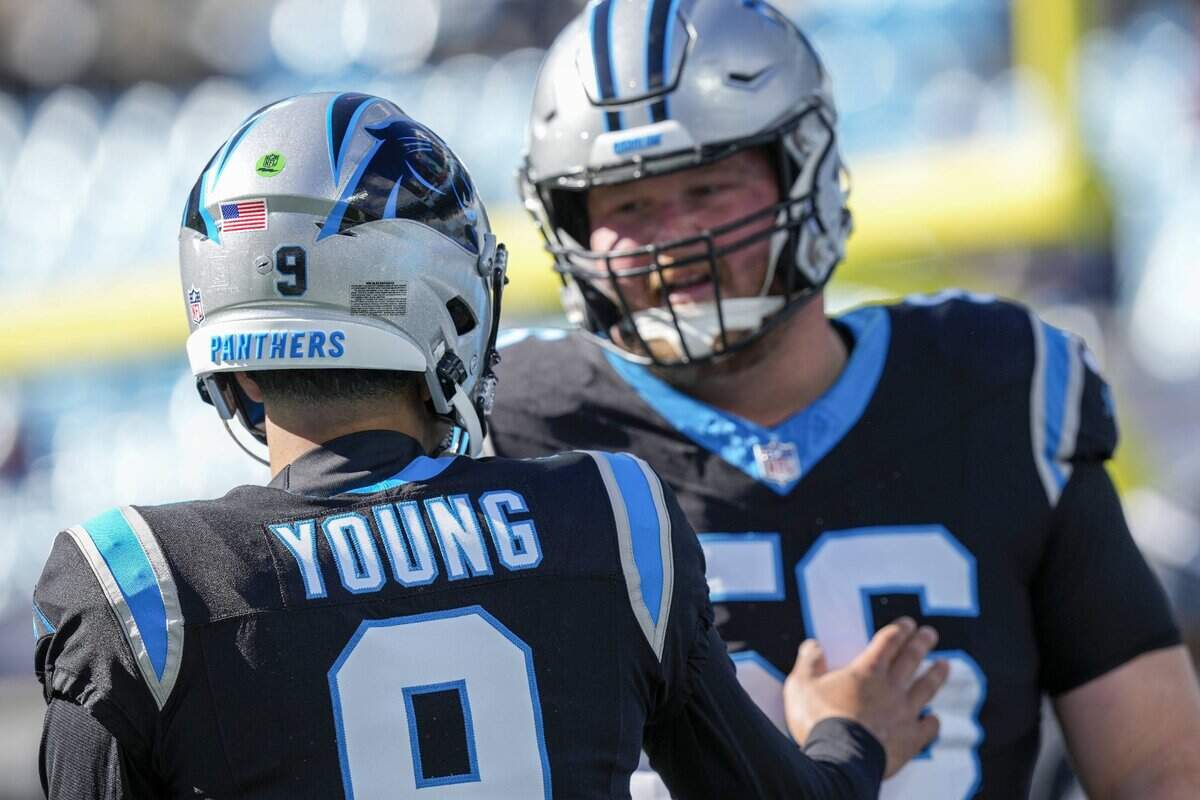 Jan 7, 2024; Charlotte, North Carolina, USA;  Carolina Panthers quarterback Bryce Young (9) shakes hands with center Bradley Bozeman (56) during pregame warm ups against the Tampa Bay Buccaneers at Bank of America Stadium. Mandatory Credit: Jim Dedmon-USA TODAY Sports