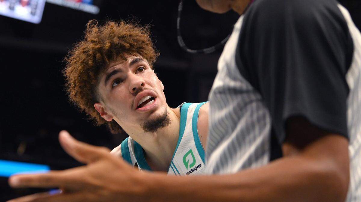 Charlotte Hornets guard LaMelo Ball, left, questions a no-call with referee Sean Corbin, right, during first half action against the Indiana Pacers at Spectrum Center in Charlotte, NC on Wednesday, November 16, 2022.