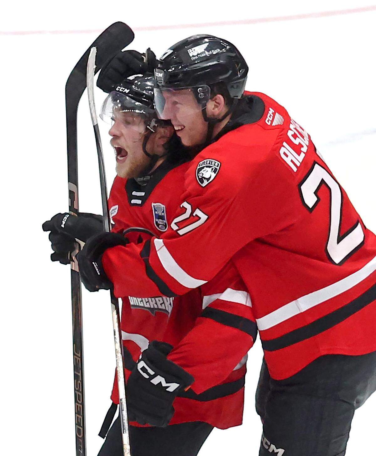 Charlotte Checkers Mike Benning, left, is congratulated by teammate Marek Alscher, right, following Benning’s game winning goal against the Canucks during overtime in the Calder Cup on Sunday, June 15, 2025 at Bojangles Coliseum in Charlotte. The series is tied at 1-1.