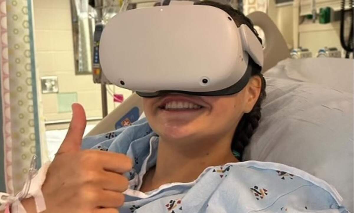 Lulu Gribbin, photographed wearing a Meta Quest headset in her hospital bed in Charlotte last summer.
