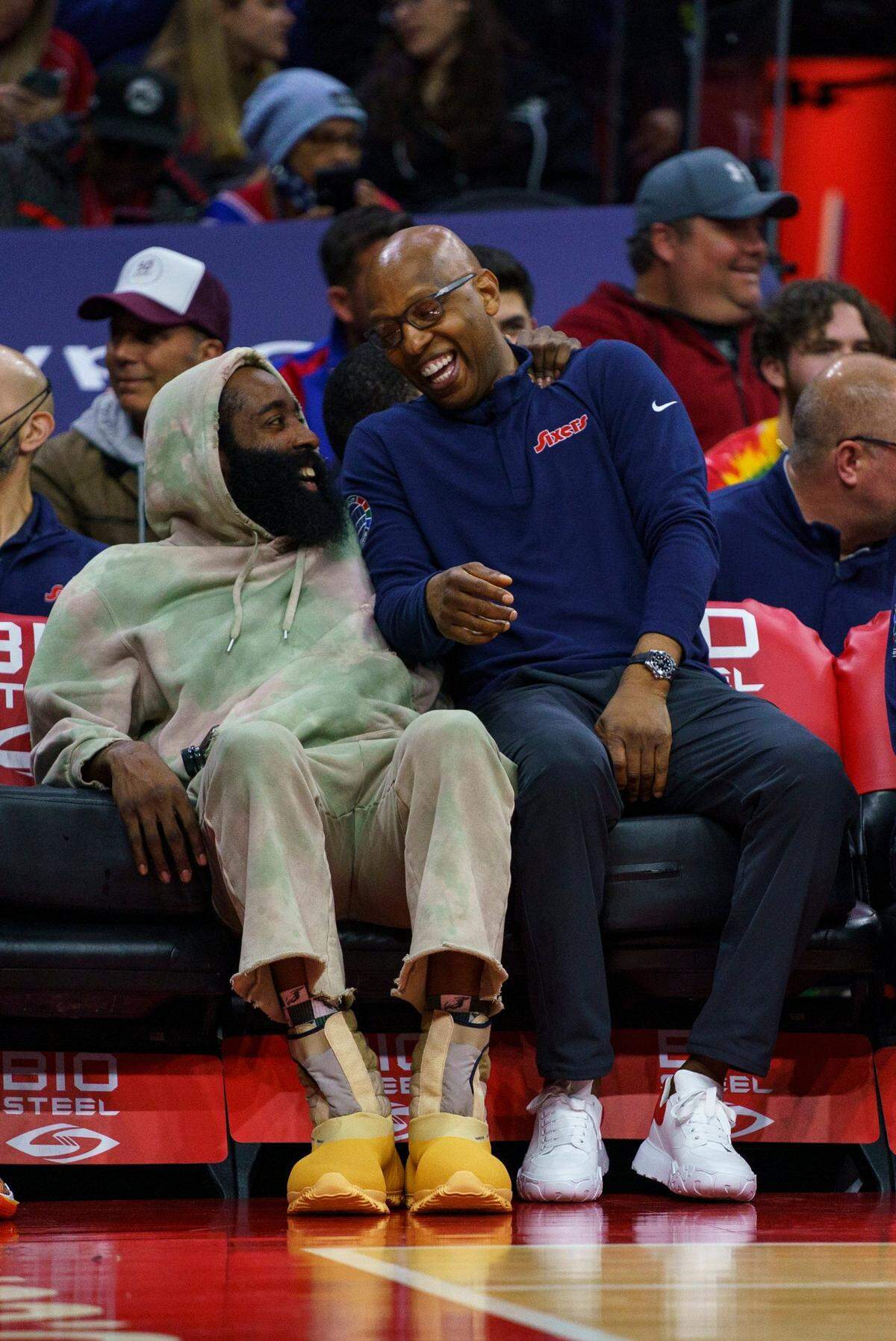Philadelphia 76ers’ James Harden, left, talks with assistant coach Sam Cassell, right, during an NBA basketball game against the Detroit Pistons, Sunday, April 10, 2022, in Philadelphia. The 76ers won 118-106. (AP Photo/Chris Szagola)