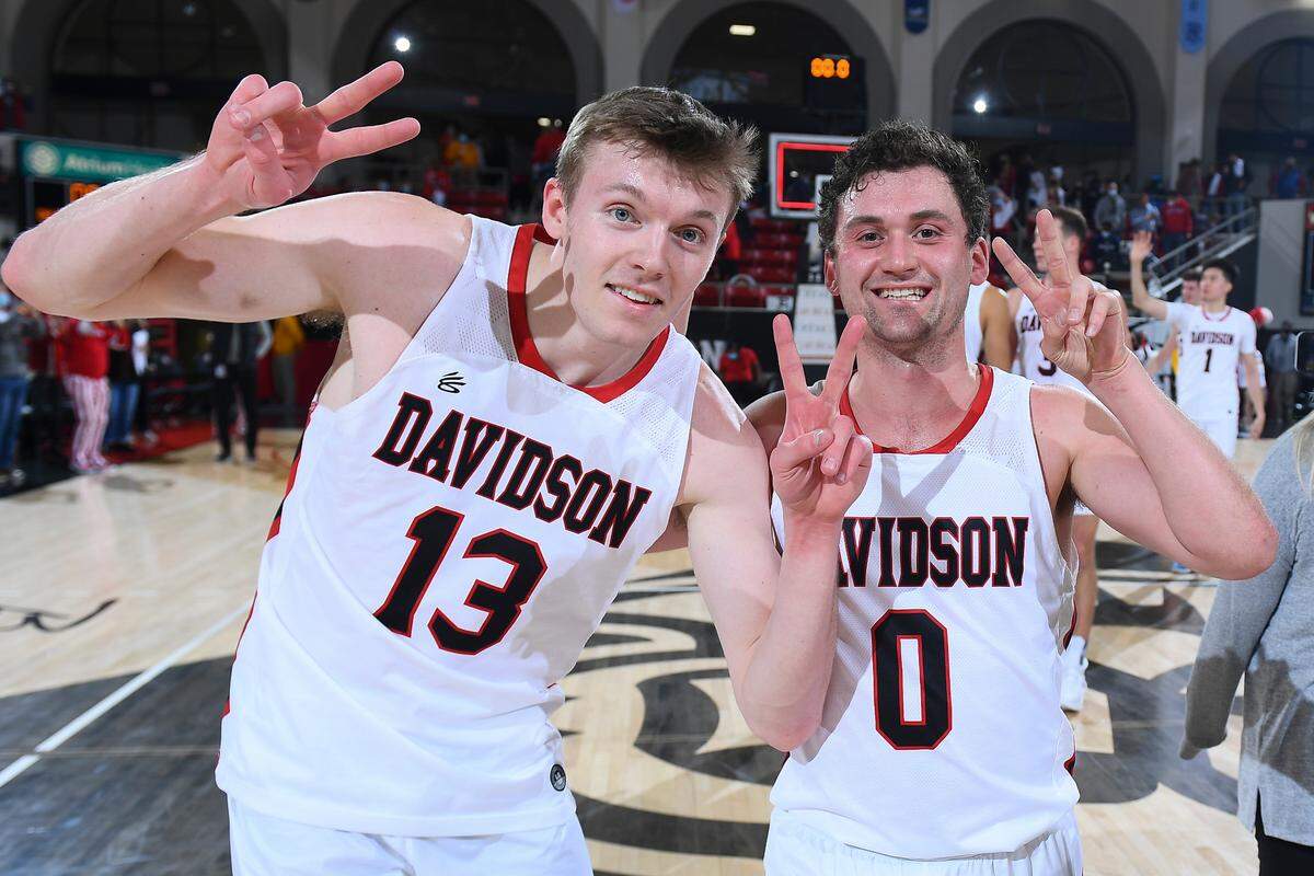 Davidson teammates Michael Jones (13) and Foster Loyer (0) celebrate after the Wildcats won their 12th straight game on Jan. 11, 2022. Davidson beat Massachusetts, 77-67.