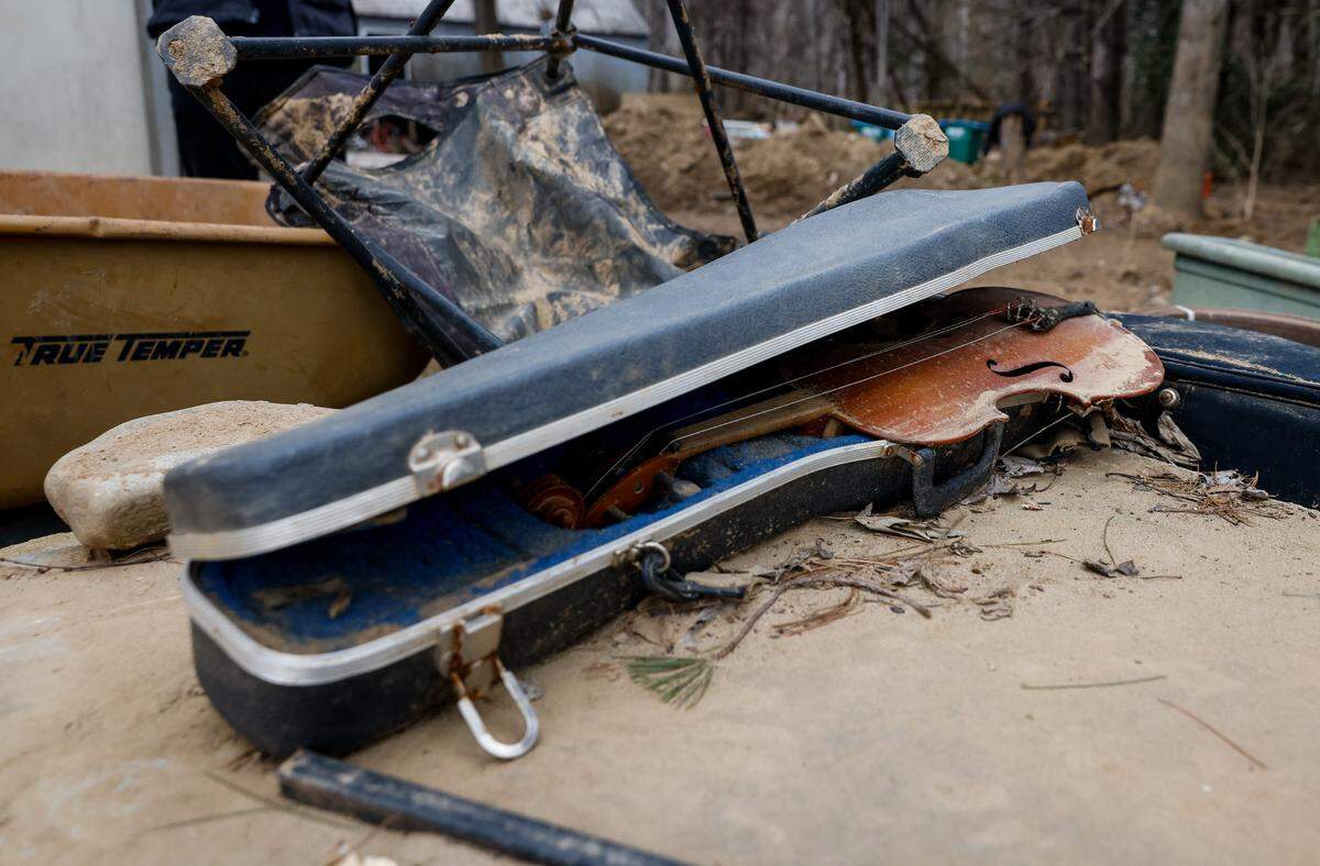 A violin airs out after flood waters destroyed Sabrina Mills’ Swannanoa house and most of their belongings. Despite the destruction, they recovered a few items not stolen by looters.