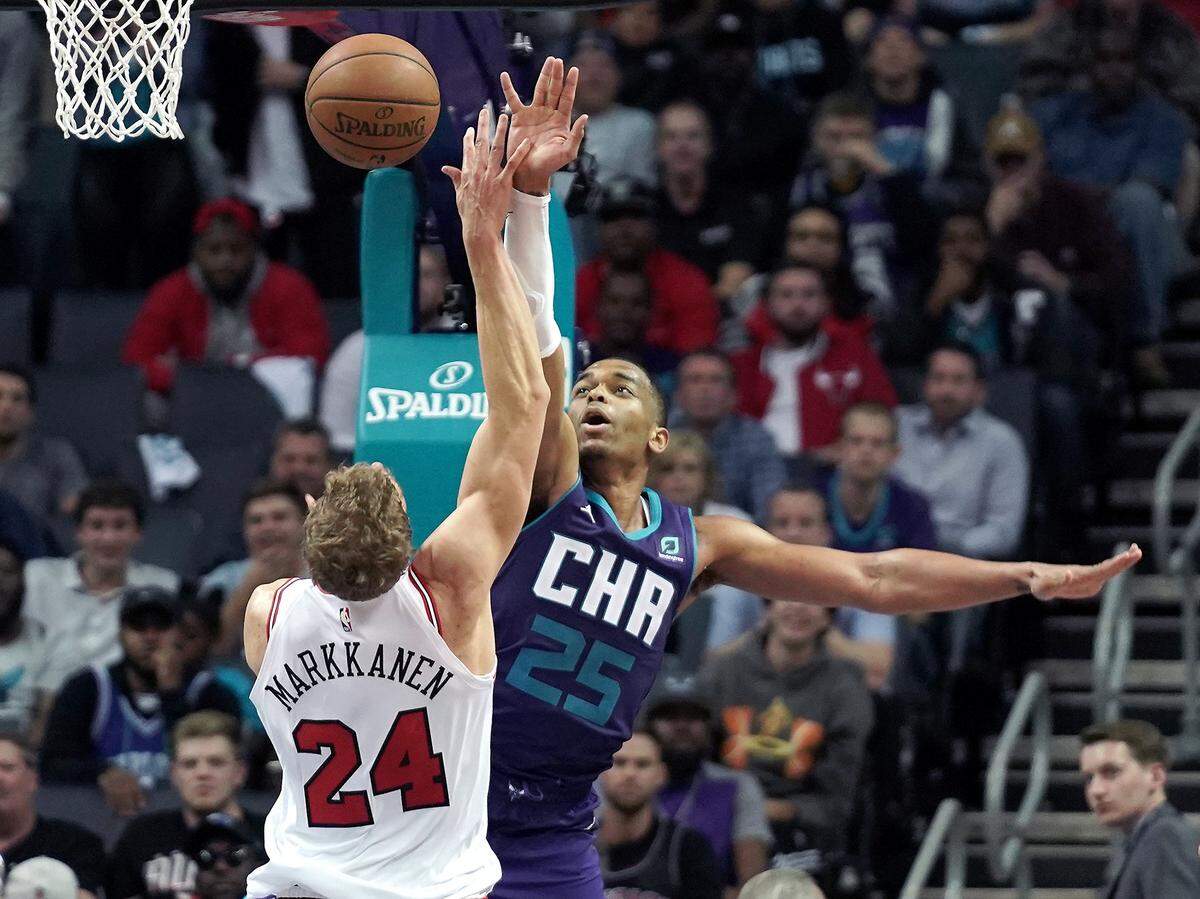 Charlotte Hornets forward P.J. Washington Jr., right, goes for a block of Chicago Bulls forward Lauri Markkanen Wednesday. The Hornets defeated the Bulls 126-125, led by Washington’s 27 points.
