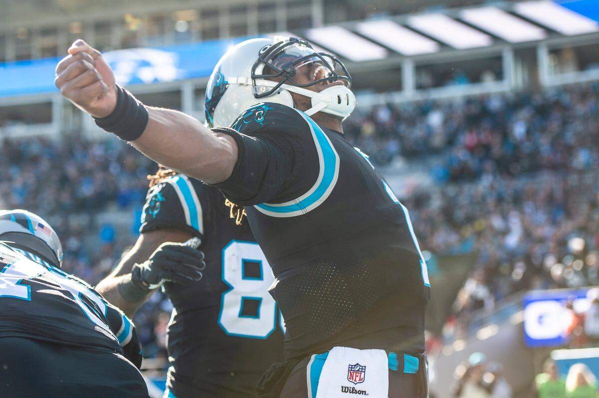 Panthers quarterback Cam Newton celebrates after scoring a rushing touchdown in the first quarter during the game against the Atlanta Falcons at Bank of America Stadium on Sunday, December 12, 2021 in Charlotte, NC.