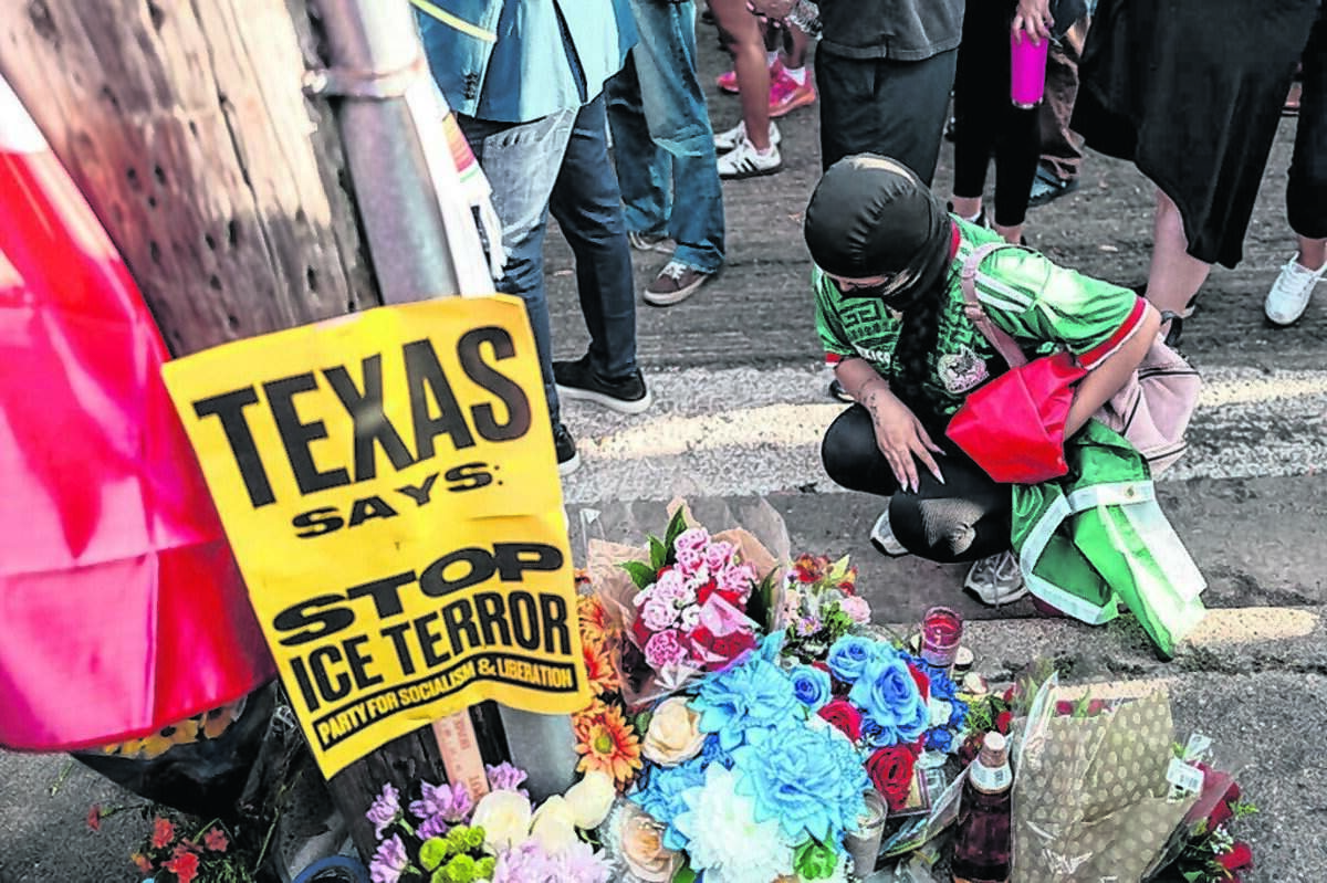 A person pays their respects at the site where Mexican immigrant Lorenzo Salgado Araujo was killed on July 8 in Houston, Texas. An Immigration and Customs Enforcement officer fatally shot him during an attempted traffic stop arrest.