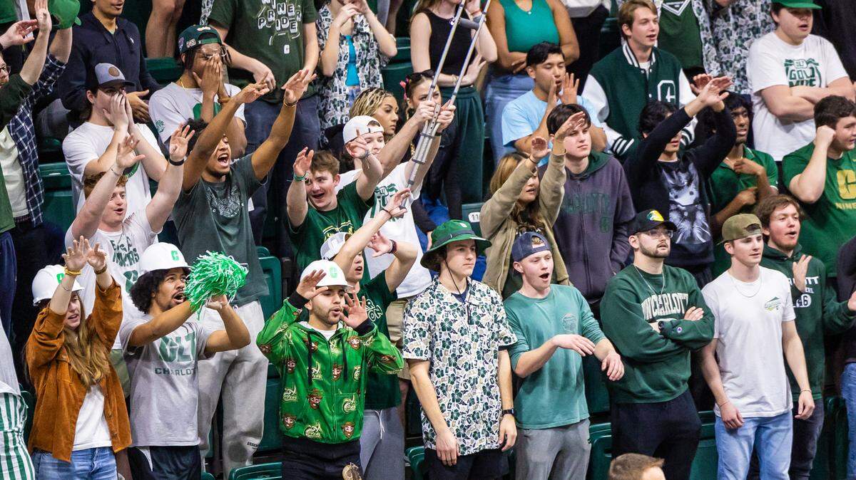 UNC Charlotte students cheer at a basketball game this year. Enrollment at the university jumped 11% between 2014 and 2023, with an increasing number of students coming from outside Mecklenburg County.